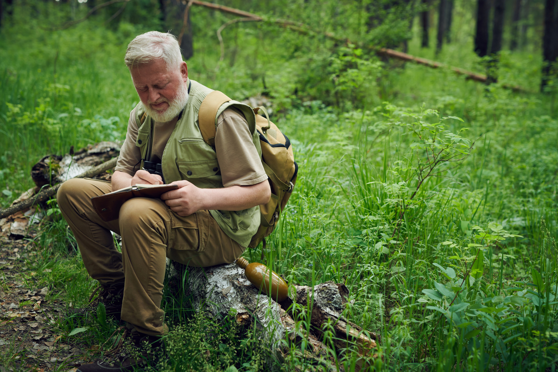 Naturalist Making Notes In His Notebook
